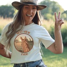 a woman wearing a white t - shirt with the words best view ever written on it