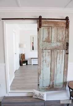 an old door is opened to reveal a sign