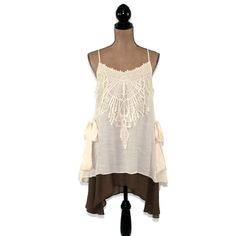 This layered dress features spaghetti straps crossed at the back and a romantic boho, mori vibe. The lace applique on the bodice and side ties also add a 20's style flapper feel to this unique loose fitting chemise. I love the creamy beige and brown combo and the high low hemline. Also available in Blue/Gray here: https://www.etsy.com/listing/656680524/romantic-clothes-layered-dress-boho-mini?ref=shop_home_active_7 Each piece in our HEART ALTERED collection has been embellished with our signatur Bohemian Dresses With Straps, Bohemian Dress With Lace Patchwork And Spaghetti Straps, Bohemian Spaghetti-strap Dress With Lace Patchwork, Bohemian Dress With Spaghetti Straps And Ruffles, Bohemian Spaghetti Strap Dress With Ruffles, Bohemian Sleeveless Dress For Layering, Bohemian Lace Camisole For Spring, Bohemian Brunch Dresses With Straps, Spring Bohemian Lace Camisole