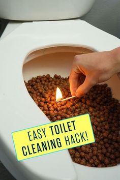 a person lighting a candle in a toilet