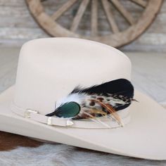 "This handmade arrangement of feathers is the perfect way to set your hat apart from the rest. Simply tuck into the band of any hat. Made with a mix of goose and rooster feathers, and an iridescent green pheasant feather at the front. Approximately 7 inches long, sizes may vary due to being made with natural materials.  Includes: 1 Handmade Arrangement of Feathers. How to use: Tuck into the hat band of any hat. *Hat not included. Hand made  Kaweah meaning \"crow cry\" or \"happy land\". Pronounc Custom Feather Hat Bands For Country Events, Feathered Brimmed Felt Hat For Ranch, Brimmed Felt Hat With Feathers For Ranch, Brimmed Hat Bands With Feathers For Rodeo, Ranch Brimmed Felt Hat With Feathers, Western Hat Bands With Feathers For Rodeo, Western Wide Brim Top Hat With Feathers, Custom Hats With Feathers For Rodeo, Feathered Short Brim Hat Bands For Western-themed Events