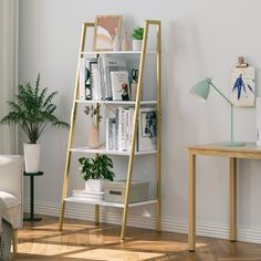 a living room with white walls and wooden flooring, a ladder shelf filled with books