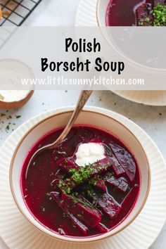 two bowls of polish borsch soup with spoons and bread on the side