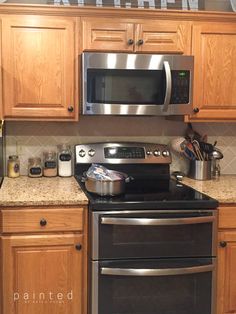 a kitchen with stainless steel appliances and wooden cabinets, including a microwave oven above the stove