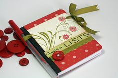 a red book with buttons on it and a green ribbon tied around the cover that says lists