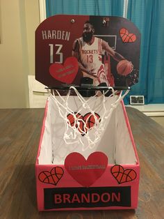 a box with a basketball in it that has been decorated for valentine's day