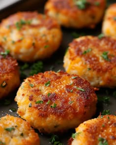 small crab cakes with parsley on top are ready to be cooked in the oven