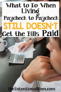 a man sitting at a table with a calculator and paperwork