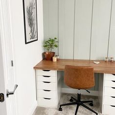 an office desk with drawers and a chair in the corner next to it on top of a carpeted floor