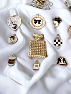 many different types of brooches on a white cloth