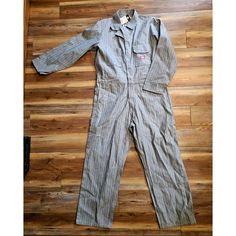 VINTAGE DICKIES HERRINGBONE STRIPED DENIM MECHANIC COVERALL JUMPSUIT 44R COLLECTIBLE WORKWEAR MEMORABILIA. THIS IS A GREAT PAIR OF DICKIES OVERALLS SIZE 44 REGULAR SNAP ZIP UP SUIT- DEADSTOCK WITH TAGS IN VINTAGE CONDITION,PLEASE SEE ALL PHOTOS FOR DETAILS. **WE HAVE OVER 1,500 VINTAGE ITEMS ONLINE - BELT BUCKLES, JEWELRY, POTTERY, ANTIQUE HARDWARE, & FINE COLLECTIBLES**  THANKS FOR LOOKING AND BE SURE TO CHECK OUT OUR OTHER ITEMS! WE HAVE LOTS OF VINTAGE ITEMS. WE PUT NEW LISTINGS ON DAILY SO CHECK BACK OFTEN. DON'T FORGET TO ADD US TO YOUR FAVORITES LIST! HUGHES-ANTIQUE CHECK OUT OUR NEW WEBSITE !   https://hughesantiques.com item# Vintage Cotton Jumpsuits And Rompers For Work, Vintage Cotton Denim Jumpsuit With Button Closure, Fitted Vintage Denim Jumpsuit With Long Sleeves, Vintage Fitted Long Sleeve Denim Jumpsuit, Vintage Long Sleeve Jumpsuit For Work, Vintage Long Sleeve Jumpsuits And Rompers For Work, Vintage Fitted Overalls For Workwear, Vintage Jumpsuits And Rompers For Workwear, Vintage Denim Workwear Jumpsuit