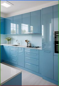 a kitchen with blue cabinets and white counter tops