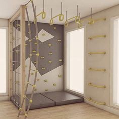 an empty room with climbing ropes hanging from the ceiling