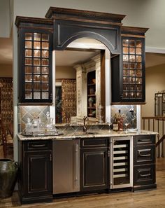 a large kitchen with black cabinets and marble counter tops is pictured in this image from the inside