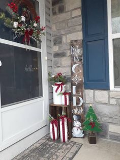 the front porch is decorated for christmas with holiday decorations and gifts on display in boxes