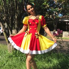 a woman in a costume standing on the grass