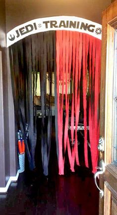 the entrance to a training facility with red and black ribbons hanging from it's doors