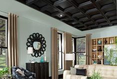 a living room filled with furniture and windows covered in black tint coverings on the ceiling