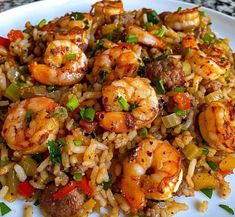 a white plate topped with rice and shrimp