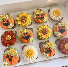 twelve decorated cupcakes in the shape of pumpkins and sunflowers