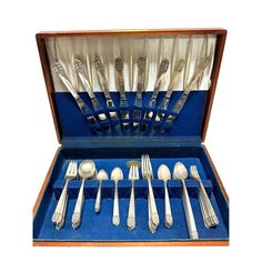 an assortment of silverware in a blue case