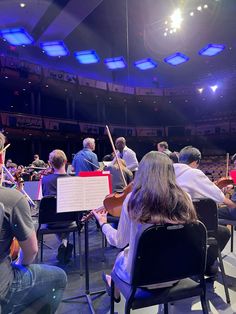 a group of people sitting in chairs playing instruments