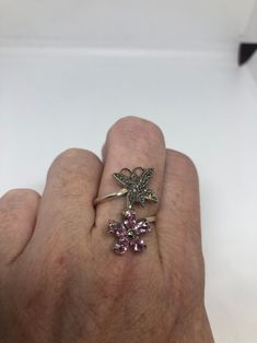 Vintage ring surrounded by Swiss cut fine Marcasite and pink ice Sterling silver Size 7 can be sized by my jeweler. His service charge is $10-$15 All rings are shipped in a nice gift box. Check out our over a THOUSAND great reviews Engraving is $4 per letter and is not always perfect depending on the piece. It can take a few days if the jeweler is busy. This is payable to Paypal Judithsltd@gmail.com Pink Sterling Silver Crystal Open Ring, Pink Sterling Silver Crystal Ring With Gem, Sterling Silver Pink Flower Promise Ring, Pink Sterling Silver Flower Promise Ring, Pink Sterling Silver Rings With Accent Stones, Pink Sterling Silver Birthstone Ring As Gift, Pink Sterling Silver Open Ring Jewelry, Sterling Silver Flower Ring With Accent Stones For Gift, Pink Sterling Silver Flower Ring As Gift