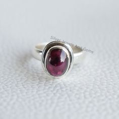 Gemstone-Garnet Shape-Oval Metal-925 Sterling Silver This One of a kind ring is adorned with beautiful Garnet Gemstone set in sterling silver. About gemstones-Garnet is intense red colour stone resembling the glistening, deep red seeds of the fruit. This red stone is associated with true friendship, devotion,loyalty, self esteem, success and passion. Garnet protects from negativity and warn off evil spirits and leads way to spiritual world.Wearing Garnet stone promotes good health and enhances b Oval Cabochon Ruby Ring For Anniversary, Oval Ruby Cabochon Rings, Oval Cabochon Garnet Rings For Anniversary, Oval Garnet Rings, Oval Garnet Rings As Gift, Oval Garnet Ring For Gift, Oval Cabochon Ruby Ring Gift, Sterling Silver Oval Cabochon Ruby Ring Gift, Silver Ruby Ring With Oval Cabochon