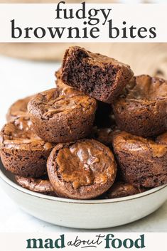 chocolate fudge brownie bites stacked on top of each other in a white bowl