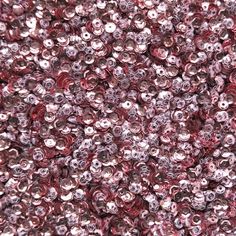 red and silver sequinized beads are shown in this close up photo, with the background