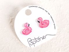 Make a splash with our cute handmade flamingo pool floatie stud earrings! These adorable accessories are perfect for anyone who loves the beach, pool parties, and a touch of playful in their wardrobe. Each earring is handmade and hand-illustrated, ensuring that no two are exactly alike. The earrings are coated in glossy resin and made with hypoallergenic nickel-free titanium earring posts - perfect for people with metal allergies! These earrings are highly water resistant, but please care for th Novelty Pink Earrings For Summer, Pink Summer Jewelry For Gifts, Pink Summer Style Jewelry For Gifts, Pink Summer Style Jewelry As A Gift, Summer Style Pink Jewelry As Gift, Handmade Pink Summer Jewelry, Cute Adjustable Earrings For Beach, Cute Adjustable Earrings For The Beach, Trendy Pink Earrings For Vacation