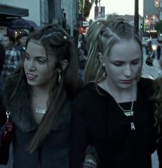 two young women walking down the street together