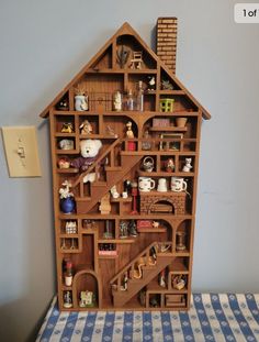 a doll house made out of wooden shelves