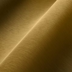 an image of a gold colored fabric textured with thin lines and folds on the surface