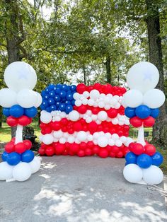 an american flag balloon arch with red, white and blue balloons