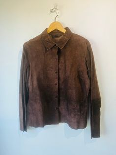 Vintage Express Chocolate Brown Suede Jacket in excellent vintage condition. Button down fits size S best. Raw unfinished suede in the most beautiful chocolate color. Nice matching stitching throughout back and arm panels. Unfinished edges. Dry clean. Approx. Measurements: Length: 27" Underarm to underarm: 20" Fitted Brown Leather Button-up Jacket, Fitted Brown Leather Jacket With Buttons, Fitted Brown Leather Jacket With Collar, Fitted Brown Leather Collared Jacket, Brown Collared Leather Jacket With Buttons, Brown Collared Leather Jacket With Snap Buttons, Brown Leather Jacket With Snap Buttons, Brown Suede Leather Jacket With Buttons, Brown Suede Outerwear With Buttons