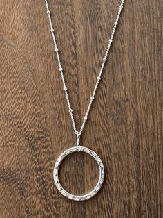 Gorgeous large sterling hammered hoop is the focal of this necklace, embellished with faceted satellite ball sterling chain, and a sterling clasp and components. 18.5 inches long. Perfect for any occasion, but certainly a show stopper for holiday parties! Silver Satellite Chain Necklace With Round Pendant, Everyday Silver Faceted Necklaces, Silver Jewelry With Round Pendant And Ball Chain, Silver Jewelry With Round Satellite Chain Pendant, Silver Satellite Chain With Round Pendant, Adjustable Sterling Silver Necklace With Satellite Chain, Sterling Silver Round Pendant Necklace With Ball Chain, Everyday Silver Hoop Necklaces, Silver Necklace With Satellite Chain