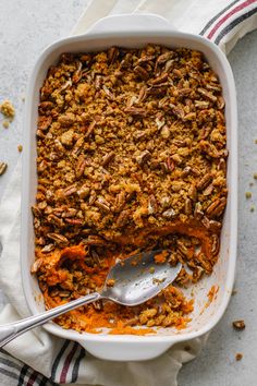 a casserole dish filled with carrots and pecans