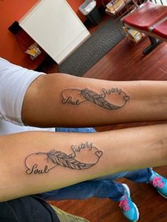 two people with matching tattoos on their legs