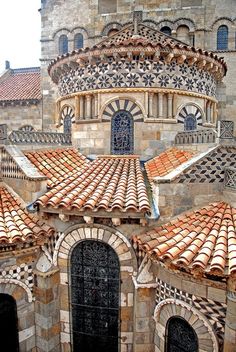 an old building with tiled roof tops and arched doorways in the middle of it