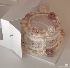 there is a cake in the box with flowers on it