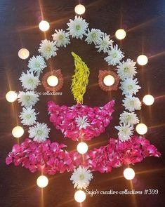 a decorated face with flowers and candles around it for diwaling on the occasion