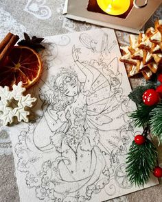 an image of a drawing on paper next to christmas decorations