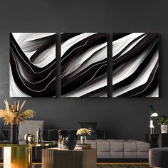 three black and white paintings in a living room