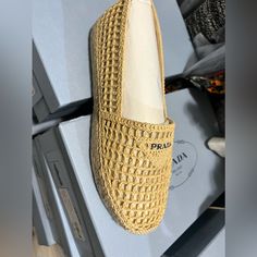 Prada Rafia Logo Espadrilles Luxury Espadrilles With Woven Sole For Vacation, Luxury Vacation Espadrilles With Woven Sole, Luxury Round Toe Espadrilles For Beach, Designer Espadrilles With Woven Sole For Vacation, Luxury Beige Espadrilles With Woven Sole, Luxury Closed Toe Espadrilles For Beach, Luxury Closed Toe Beach Espadrilles, Designer Flat Heel Espadrilles For Beach, Designer Round Toe Espadrilles For Beach