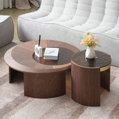 two coffee tables sitting next to each other on top of a carpeted floor in front of a couch