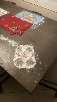 a wooden table with chalk drawings on it