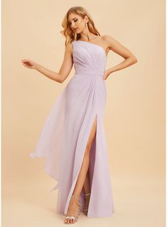 a woman in a lavender colored dress with one leg slited up and her hand on her hip