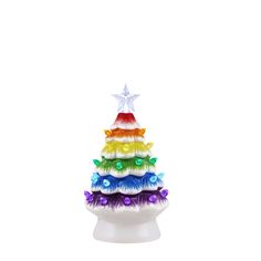 a multicolored christmas tree made out of feathers on top of a white base