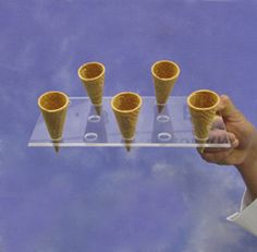 an ice cream cone display with five cones on it